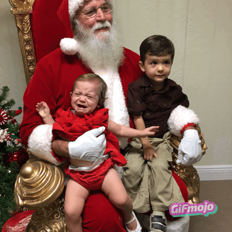 A brother and sister visiting Santa Claus for the 1st time