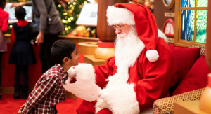 Image: A little boy shares his Christmas list with Santa