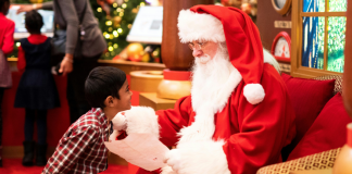 Image: A little boy shares his Christmas list with Santa