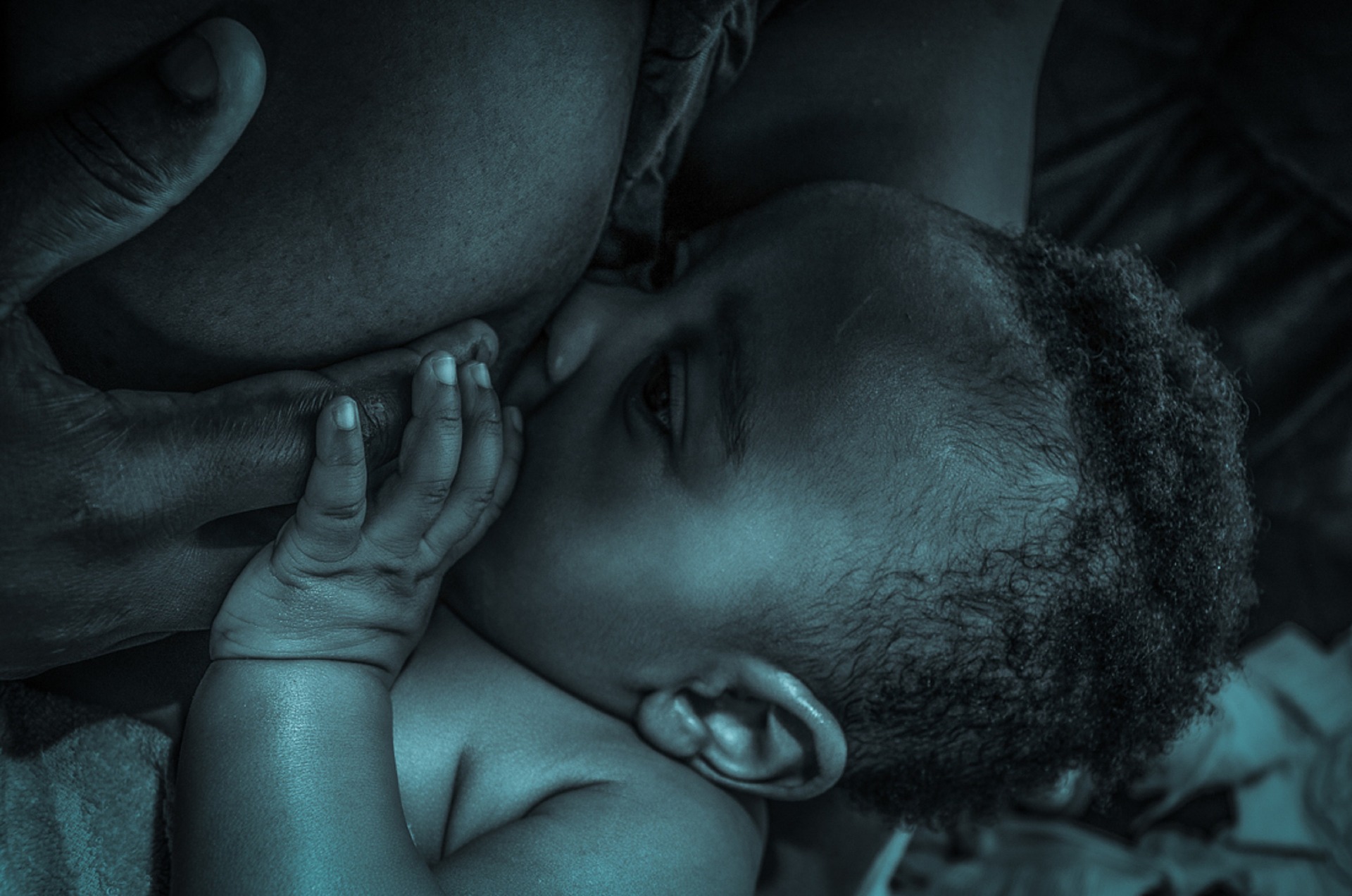 A Black mother breastfeeding her infant