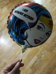 Image: A Wonder Woman stick ballon that reads, "I am Wonder Woman"