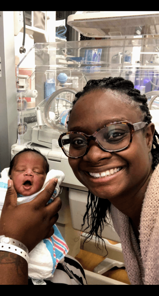 Esther McCant with a NICU newborn and birth doula client
