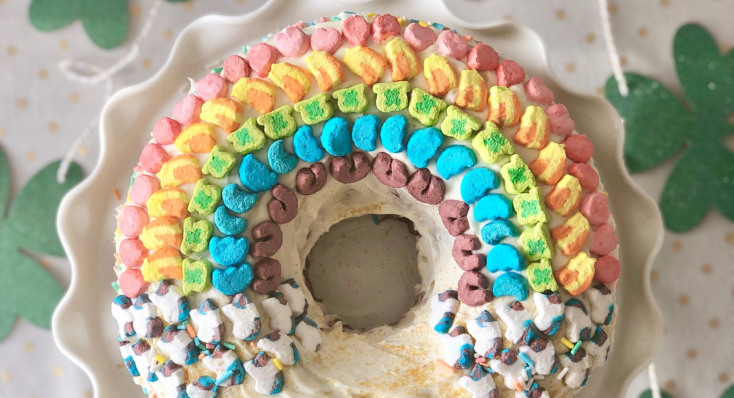 Image: A festive bundt cake decorated with a rainbow made of Lucky Charms
