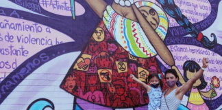 Ana with her daughter in front of a colorful street mural (International Women's Day: This Year, #ChooseToChallenge Ana Caballeros Contributor Miami Mom Collective)