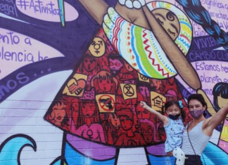 Ana with her daughter in front of a colorful street mural (International Women's Day: This Year, #ChooseToChallenge Ana Caballeros Contributor Miami Mom Collective)