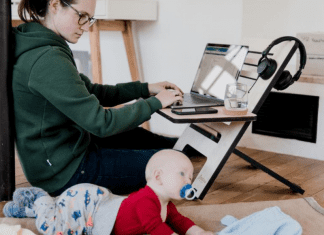 A mom working from home while watching her baby (Daycare & Preschool During the Ongoing Pandemic Bella Behar Contributor Miami Mom Collective)