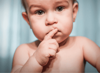 Image: A baby with a skeptical expression (I’m a Dietitian, and I Hated Feeding My Baby Solid Food (At First) | Part 1 Monica Auslander Moreno Contributor Miami Mom Collective)