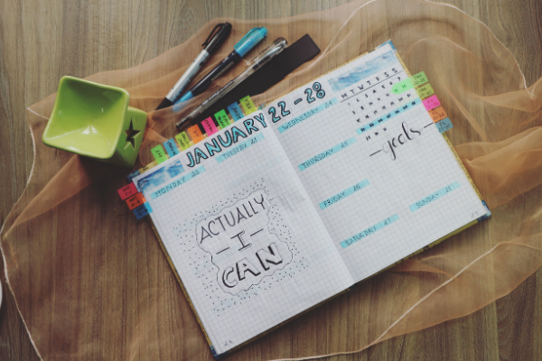 An open color-coded planner (Getting and Staying Organized: 3 Helpful Tips Krystal Giraldo Contributor Miami Mom Collective)