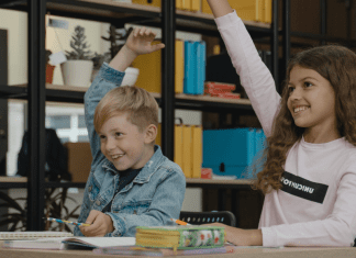 Two students raising their hands (Get Involved: 3 Ways to Help Your Student Succeed Ailyn Quesada Contributor Miami Mom Collective)