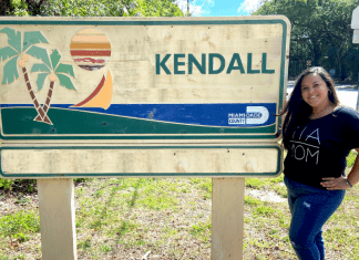 Krystal posing by a Kendall sign (Love Where You Live: Why I Love Kendall Krystal Giraldo Contributor Miami Mom Collective)