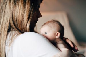 A mom holding her newborn (Choosing Joy and Enjoying the Chaos Kristin Parke Contributor Miami Mom Collective)