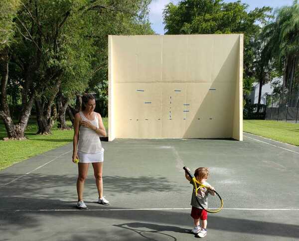 Sandra and her son at an outdoor racquetball court (Love Where You Live: Why I Love Living In Pinecrest Sandra Jacquemin Contributor Miami Mom Collective)