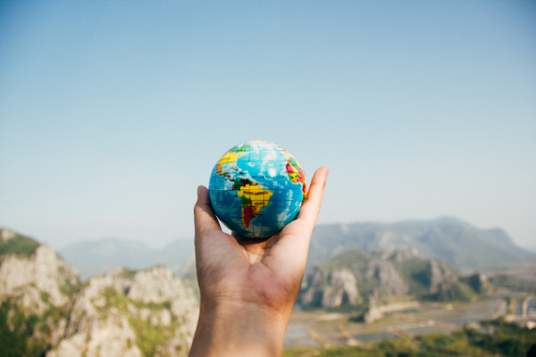 A hand holding a globe (Earth Day: 5 Meaningful Ways to Celebrate! Ana-Sofia DuLaney Contributor Miami Mom Collective)