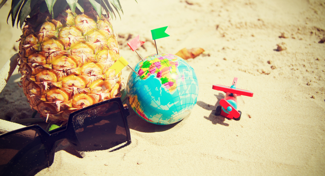 Sunglasses, a pineapple, a toy airplane, and a globe (Fighting Summer Boredom Lorena Lougedo Contributor Miami Mom Collective)