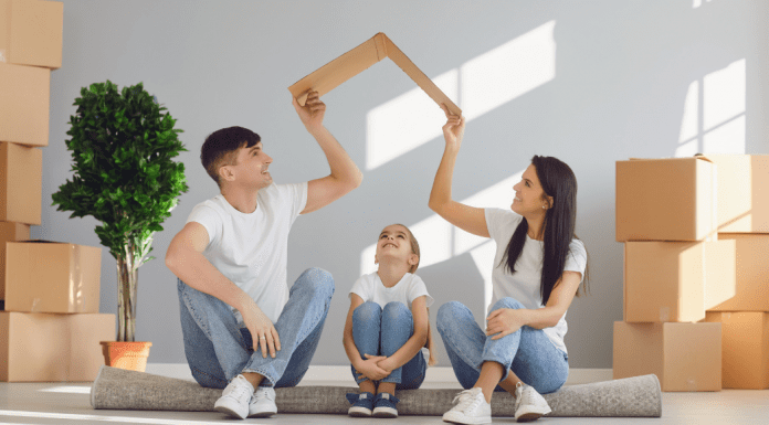 Image: A father and mother sitting on the floor with their daughter, surrounded by moving boxes (Moving with Children: 4 Helpful Tips Jessica Socarras Contributor Miami Mom Collective)