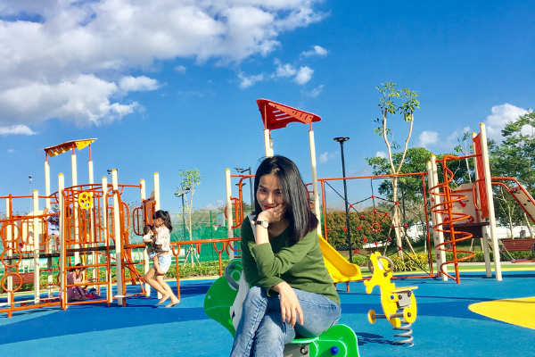 Image: A mother sitting at the playground while her children play (Moving with Children: 4 Helpful Tips Jessica Socarras Contributor Miami Mom Collective)