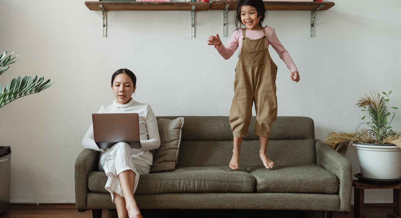 A mom working from home while her daughter plays (5 Steps to Supporting Your "Single Mom" Friends Kristen Llorca Contributor Miami Mom Collective)