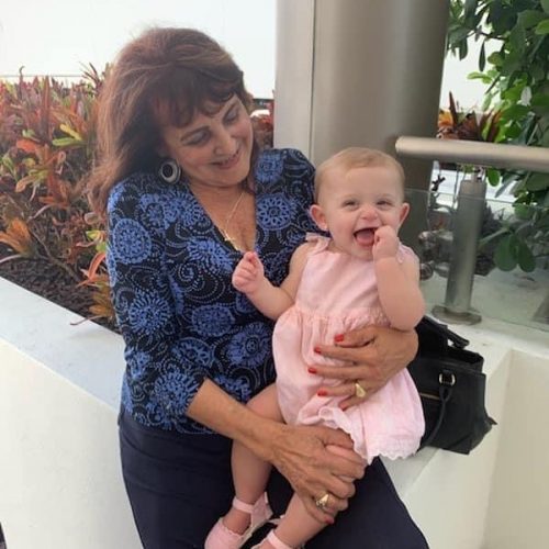 Alicia holding her great-granddaugher (Wisdom and Reflections on Motherhood by 3 Generations of Miami Moms Alisa Britton Contributor Miami Mom Collective)