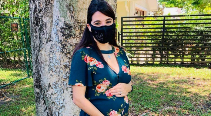 An expectant mom with her MIA Mom face mask (Booster Shots, Breakthrough Cases & the Latest on COVID Vaccine Safety Lynda Lantz Contributor Miami Mom Collective)