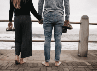 Image: A couple standing side by side on a pier
