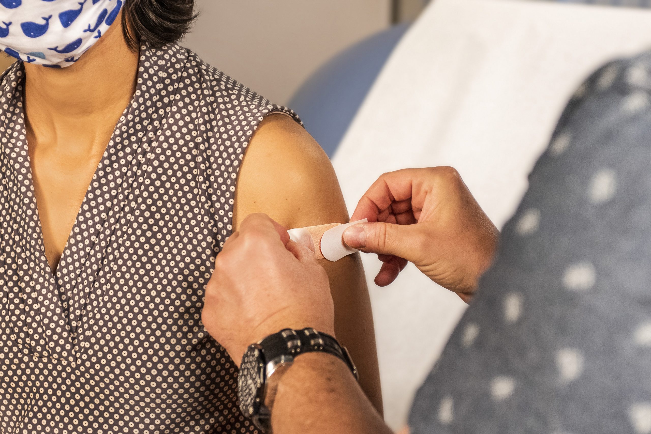 A woman receiving a COVID-19 vaccine (Booster Shots, Breakthrough Cases & the Latest on COVID Vaccine Safety Lynda Lantz Contributor Miami Mom Collective)