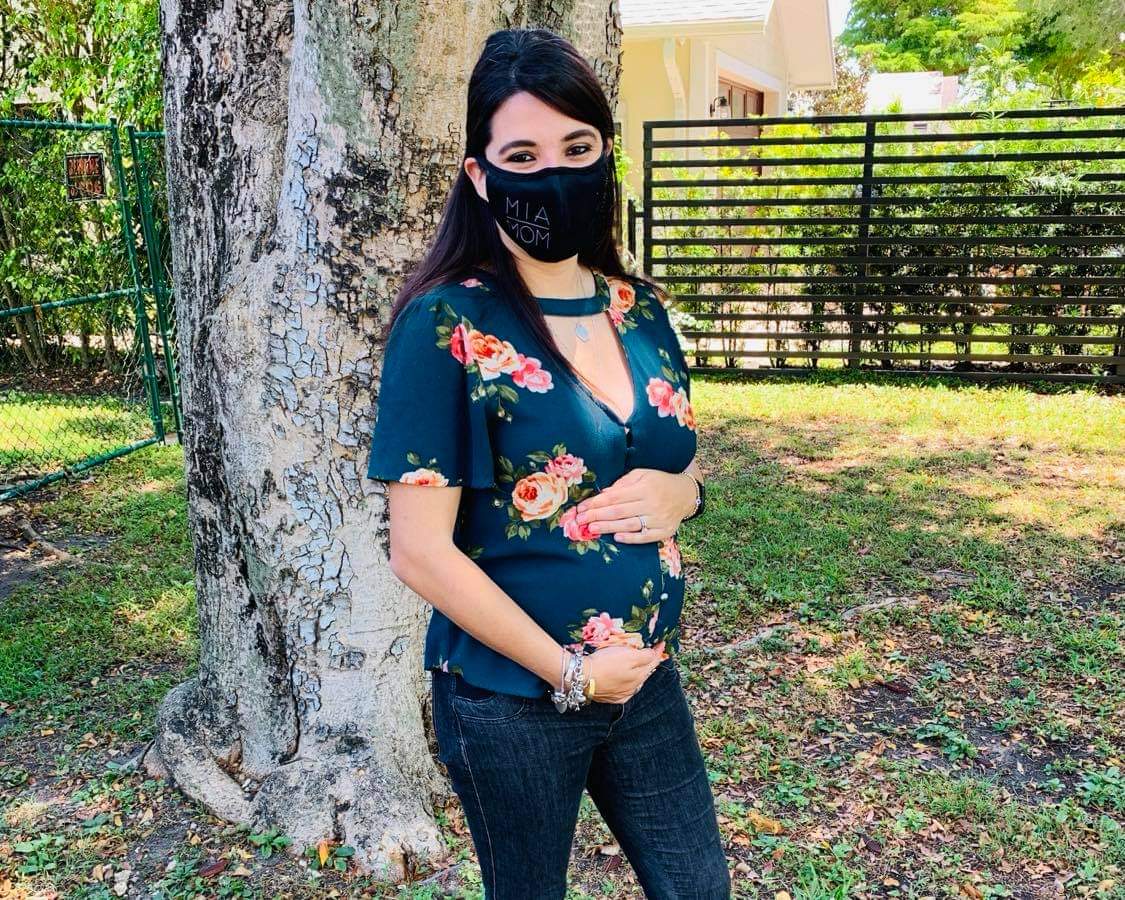 An expectant mom with her MIA Mom face mask (Booster Shots, Breakthrough Cases & the Latest on COVID Vaccine Safety Lynda Lantz Contributor Miami Mom Collective)