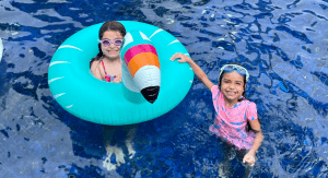 Vanessa's daughters playing in the pool (Sibling Rivalry: Tackle It With These 4 Strategies Vanessa Santamaria Contributor Miami Mom Collective)