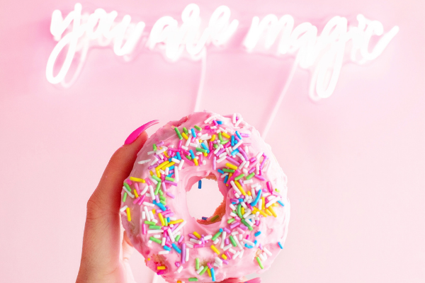 A donut with sprinkles and a sign that says "You are magic" (National Donut Day: Make it A-Glaze-ing! Ana-Sofia DuLaney Contributor Miami Mom Collective)