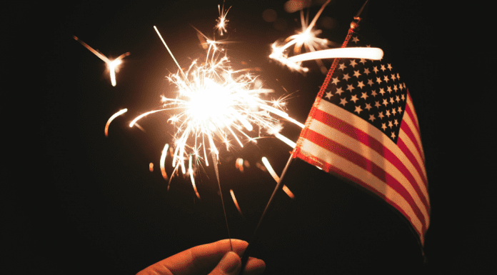 A sparkler and an American Flag (Fireworks: What to Do and Where to See Them in Miami on the 4th of July Bella Behar Contributor Miami Mom Collective)