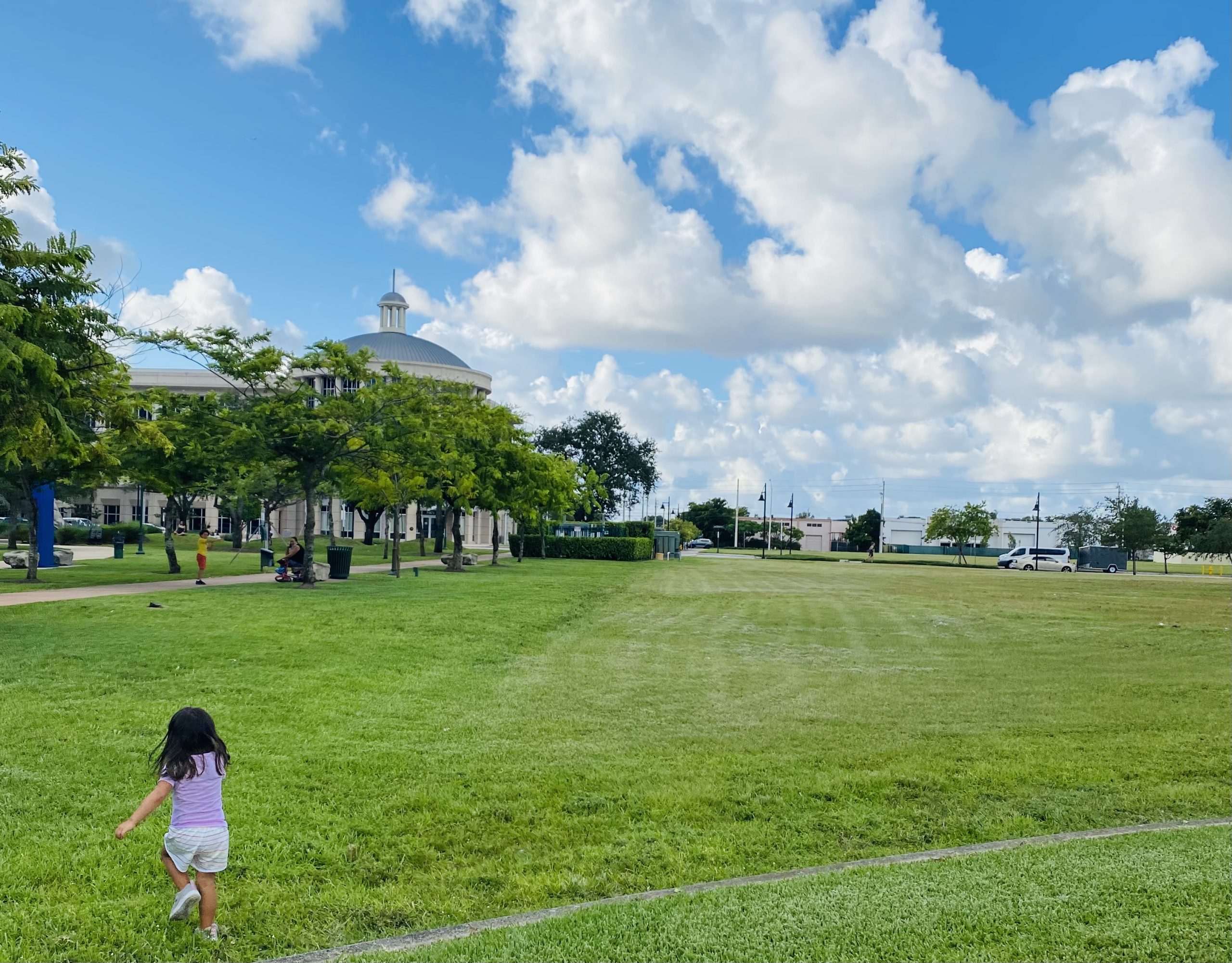 Valerie's daughter running in an open green space (Love Where You Live: Why I Love Living in Doral Valerie Barbosa Contributor Miami Mom Collective)