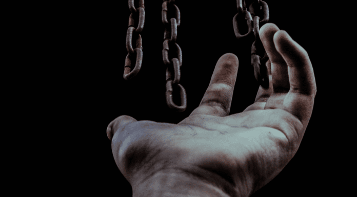Chains hanging over an open hand (Liberty and Justice for All: Why Should I Care About Juneteenth? Becky Gonzalez Contributor Miami Mom Collective)