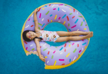 A little girl on a donut shaped inner tube