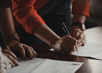 A couple signing documents (Designation of Health Care Surrogate for A Minor: What You Should Know Kristina Hernandez Tilson Contributor Miami Mom Collective)
