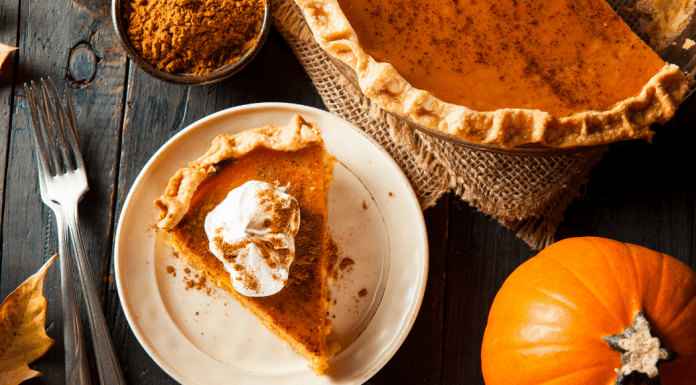Image: A slice of pumpkin pie on a festive table