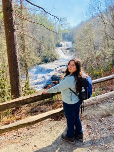 Rachel, pictured in front of a waterfall in Asheville, NC