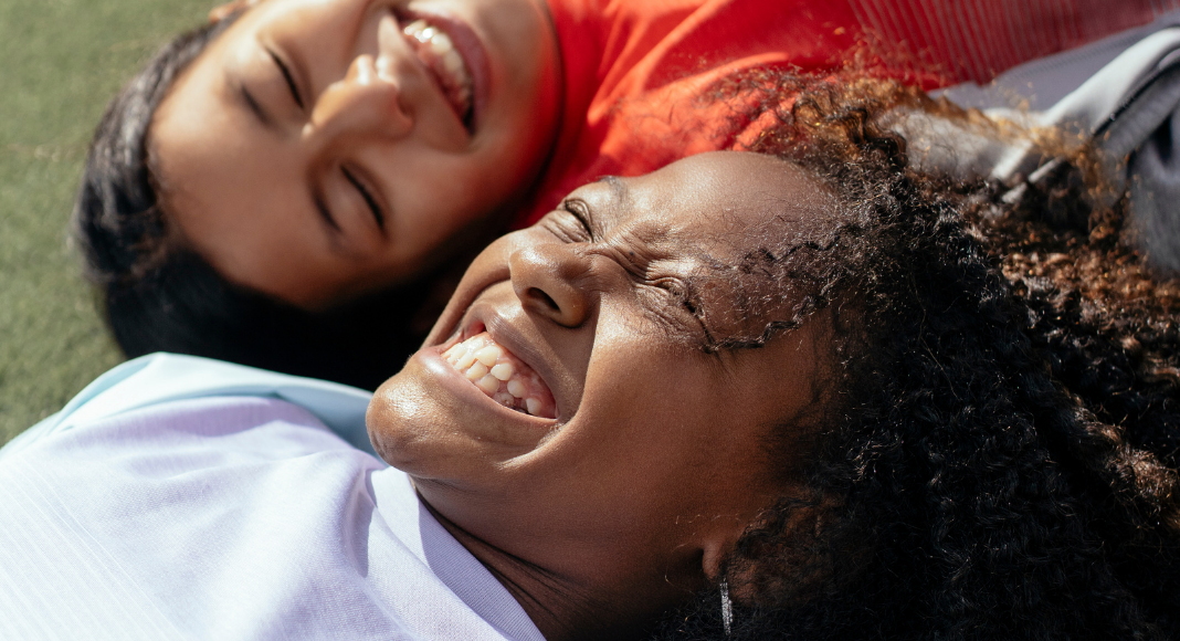 Image: Two multiethnic girls laughing and smiling together (Dental Hygiene Month: Brush Up on Oral Care | Dr. Bob Pediatric Dentist Lynda Lantz Contributor Miami Mom Collective)