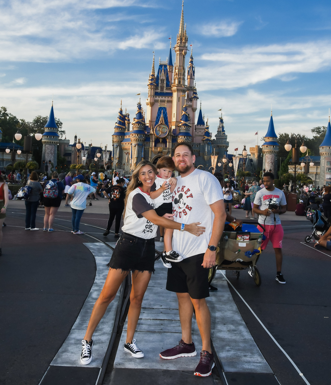Image: Sandra with her husband and son in front of Cinderella's Castle at Disney (Disney at 50: Walt Disney World's Golden Birthday Celebration Sandra Jacquemin Contributor Miami Mom Collective)