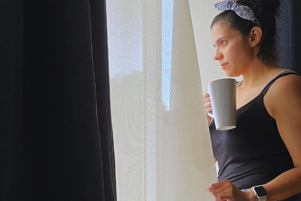 Image: Zoe holding a cup of coffee (5 Tips to Manage Stress through Motherhood Zoe Costa Contributor Miami Mom Collective)