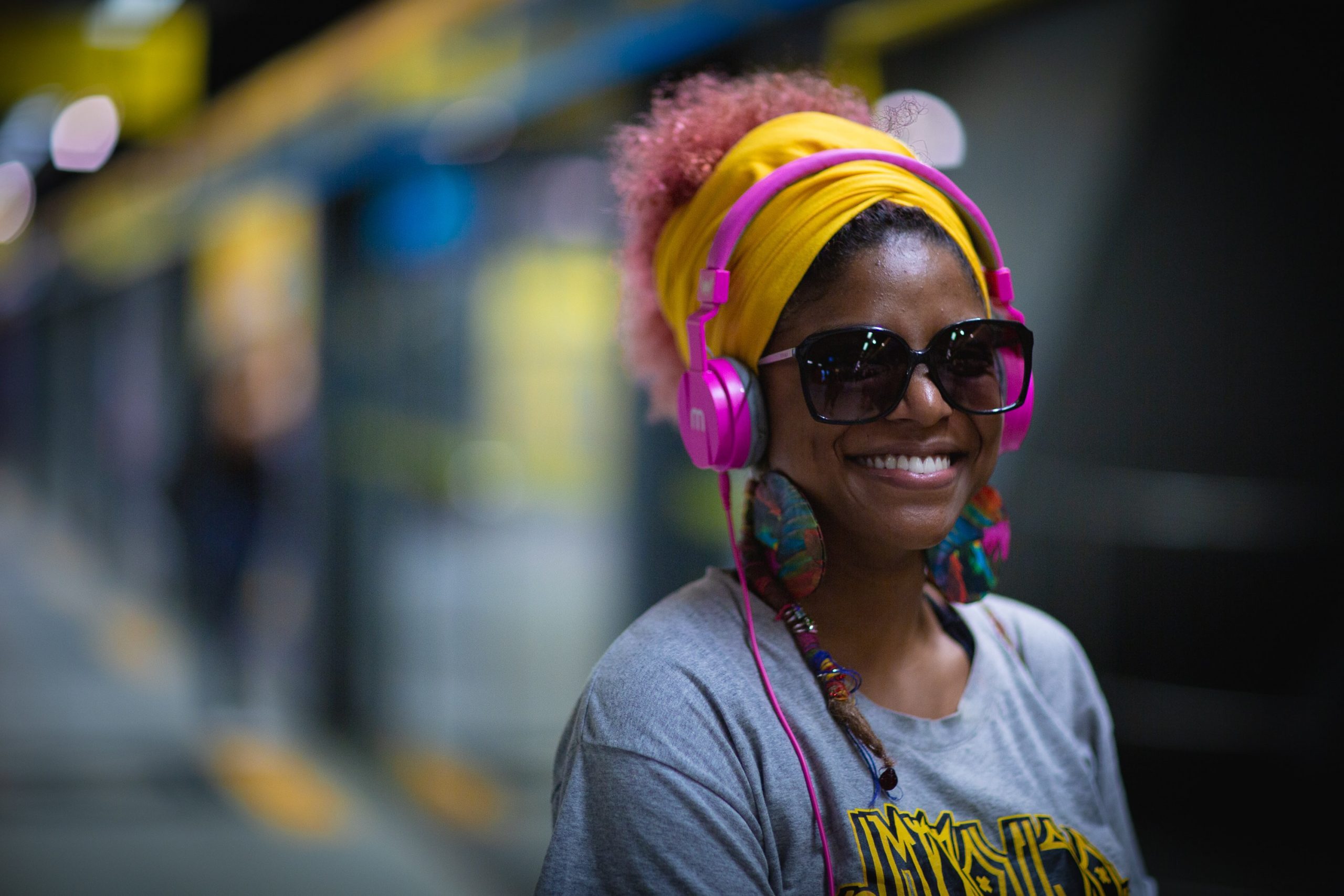 Image: A woman with headphones (Listening for My Sanity: My Top 10 Podcasts Alisa Britton Contributor Miami Mom Collective)