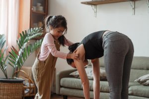 Image: A little girl helping her mom stretch (Zoe Costa Contributor Miami Mom Collective)