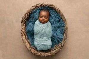 Image: A sleeping baby swaddled in a blanket (5 Tips for Your Premature Baby Brittany Aquart Contributor Miami Mom Collective)