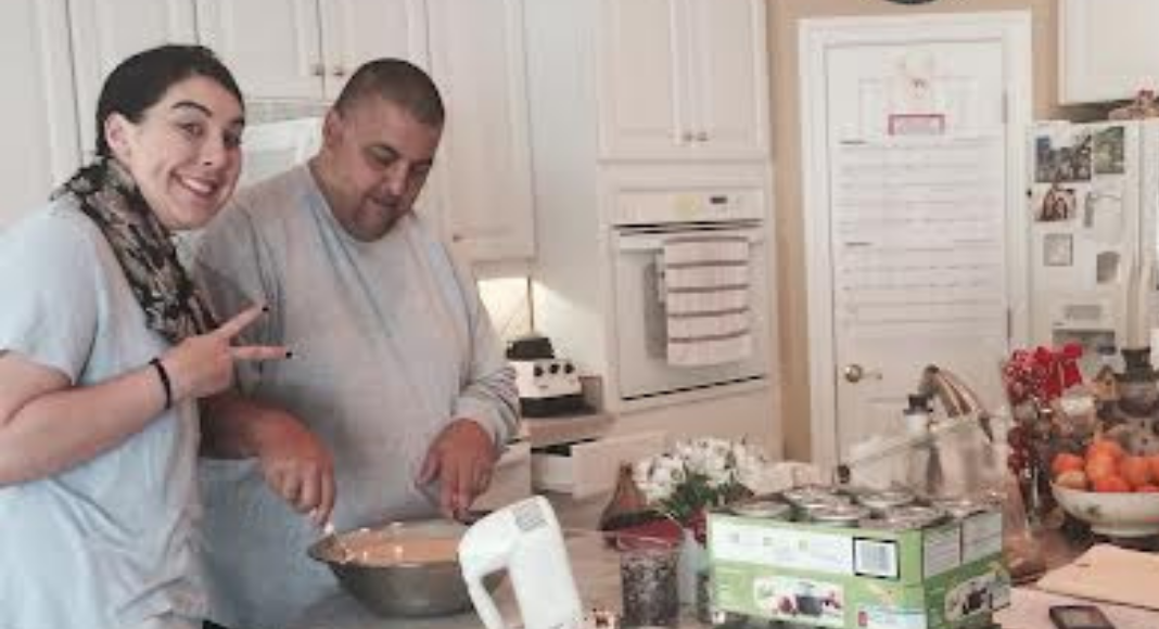 Image: Holly's husband and daughter in the kitchen prepping Thanksgiving dinner together (Sharing Thanksgiving With Our Adult Children Holly Farver Contributor Miami Mom Collective)