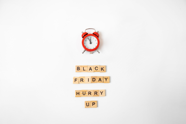 Image: An alarm clock and Scrabble letters that spell out "Black Friday, Hurry Up" (Black Friday Deals: 5 Ways to Make the Most of Them Ana-Sofia DuLaney Contributor Miami Mom Collective)