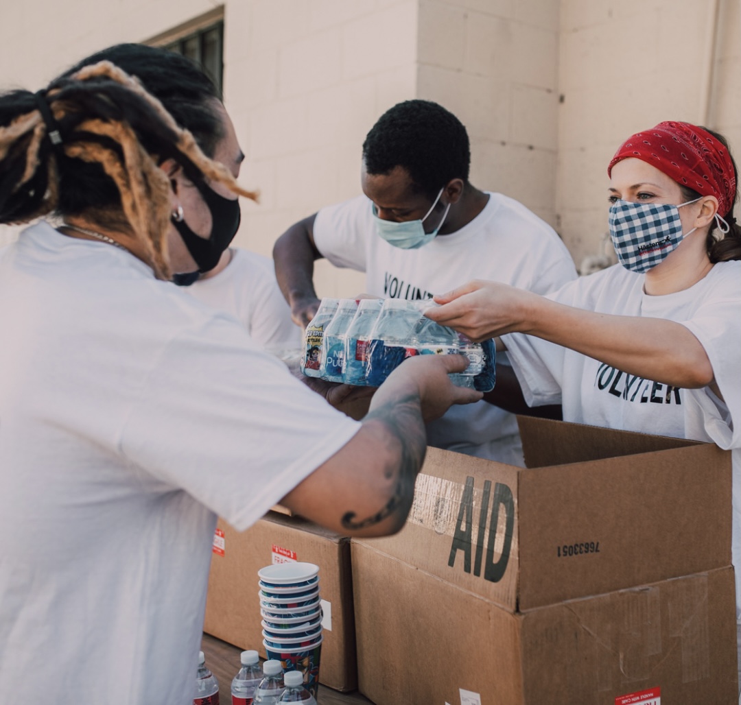 Image: Service volunteers packing aid boxes (Giving Tuesday 2021: A Global Effort to Bring the World Together Sharonda Stewart Contributor Miami Mom Collective)