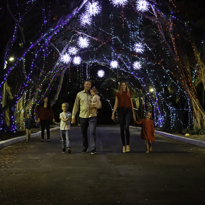 Image: A family enjoying the Nights of Lights event at Pinecrest Gardens (The Ultimate Guide to 2021 Miami Area Holiday Events & Activities Presented by Pinecrest Gardens Lynda Lantz Editor Miami Mom Collective)