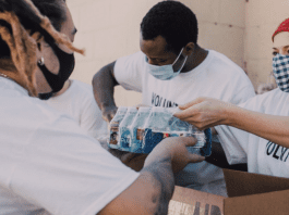 Image: Service volunteers packing aid boxes (Giving Tuesday 2021: A Global Effort to Bring the World Together Sharonda Stewart Contributor Miami Mom Collective)