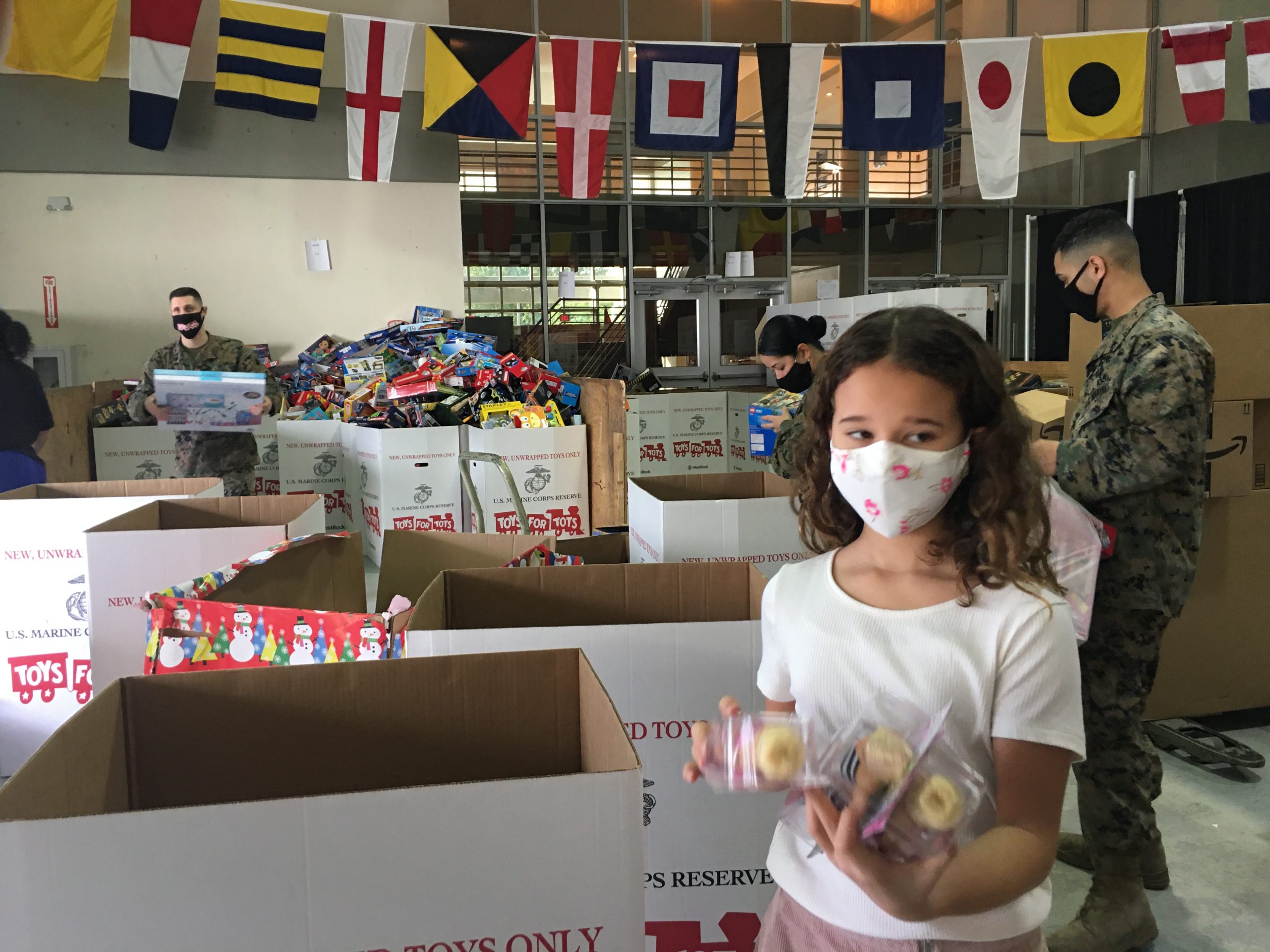 Image: Adita's daughter colleting Toys for Tots (Toys for Tots: Making a Difference for America's Children Adita Lang Contributor Miami Mom Collective)