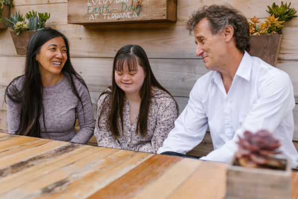 Image: A family sitting at a table together (National Scholarship Month: Special Needs Edition Krystal Giraldo Contributor Miami Mom Collective)