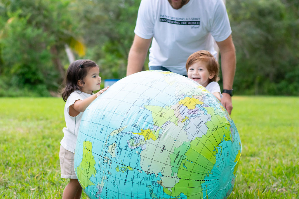 Image: Two children playing together, holding an inflatable globe (Sandra Jacquemin Contributor Miami Mom Collective)