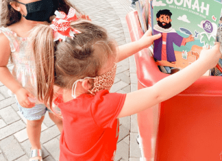 Image: A child donating a toy (Christmas: An Awesome Opportunity to Volunteer as a Family Holly Farver Contributor Miami Mom Collective)